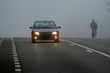 Car appearing through fog 