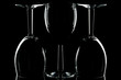 Low key shot of three wine glasses against black.