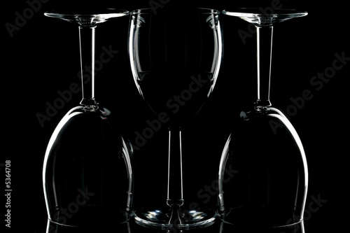 Low key shot of three wine glasses against black.
