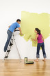 Photo: Couple painting house. Couple painting house.