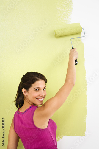 Photo: Smiling woman painting. Smiling woman painting.