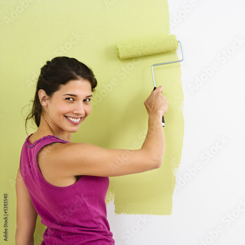 Photo: Happy woman painting. Happy woman painting.