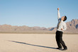 Happy businessman in the desert Happy businessman in the desert