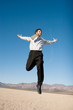 Happy businessman jumping in the air Happy businessman jumping in the air