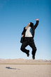 Ecstatic business man jumping in the air Ecstatic business man jumping in the air