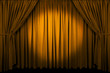 Large golden curtain with spot light and fading into dark. Large golden curtain with spot light and fading into dark.