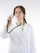 brunette in medical gown focus on the stethoscope