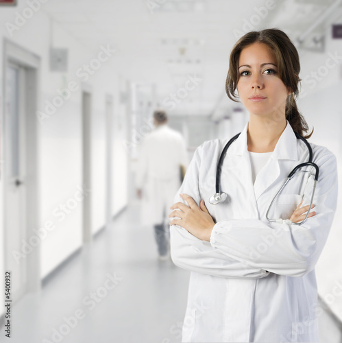 Photo: cute brunette in medical gown and a stethoscope in an hospital cute brunette in medical gown and a stethoscope in an hospital