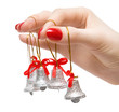 Woman hand with small bells on fingers. Isolated on white.