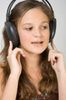 Young beauty girl listen music at headphones