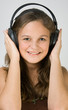 Young pretty girl listen music at headphones