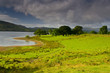 Cloudy stormy sky over the peaceful lake in Scotland.