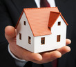 Hand of the businessman with the house