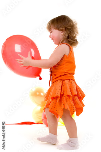 happy girl playing with colorful balloons