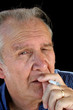 Senior male smoking a cigarette.