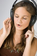 Young pretty girl listen music and singing.