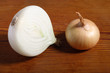Onion and a half on old wooden board
