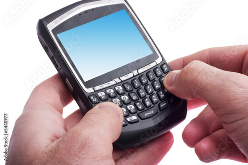 close up of hands typing on a Blackberry