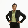 Portrait of smiling businesswoman with hands on hips.