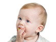 12-month old blue eyed toddler eating a piece of banana