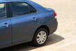 Blue car parked outside in the sun. Blue car parked outside in the sun.