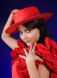 Young Spanish Flamenco dancer showing her red hat