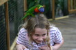 bird pecking on little girls head