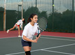 Foto: Two girls playing tennis Two girls playing tennis