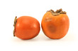 Two persimmonrs on a white background...