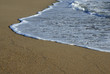white wave in the sand at the beach