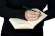 Close-up of a hand starting to write in a blank notebook Close-up of a hand starting to write in a blank notebook