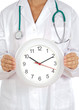 Doctor«s hands showing clock over white background Doctor«s hands showing clock over white background