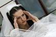 The headache on the face of the beautiful bride