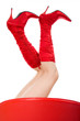 woman in red boots sitting on the red chair, studio shot