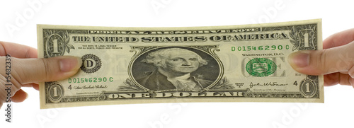 Photo: Hands stretching a US dollar note isolated on white background.. Hands stretching a US dollar note isolated on white background..