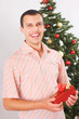 young man holding christmas present