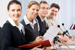 Fourconfident professionals looking at camera