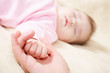 Baby hand in mather's palm.