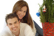 Attractive young couple hugging, full of Christmas cheer