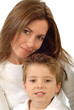 Attractive young mother holding her toddler son and smiling