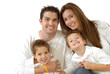 Attractive young family laughing while posing together 