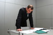 The businessman behind a table with documents The businessman behind a table with documents