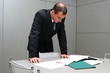 The businessman behind a table with documents The businessman behind a table with documents