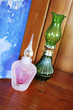 Pink and green ornaments on a shelf.