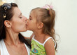Mum kisses a daughter