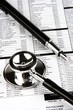 Photo: Stethoscope and fountain pen over a medical report. Stethoscope and fountain pen over a medical report.