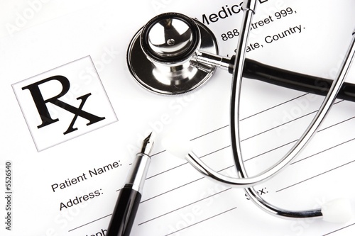 Photo: A Stethoscope over a medical report form. A Stethoscope over a medical report form.