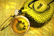 Green asian teapot with cup and green tea