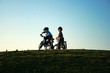 Children on bicicles in a park.