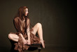 Beautiful woman wearing scarf sitting